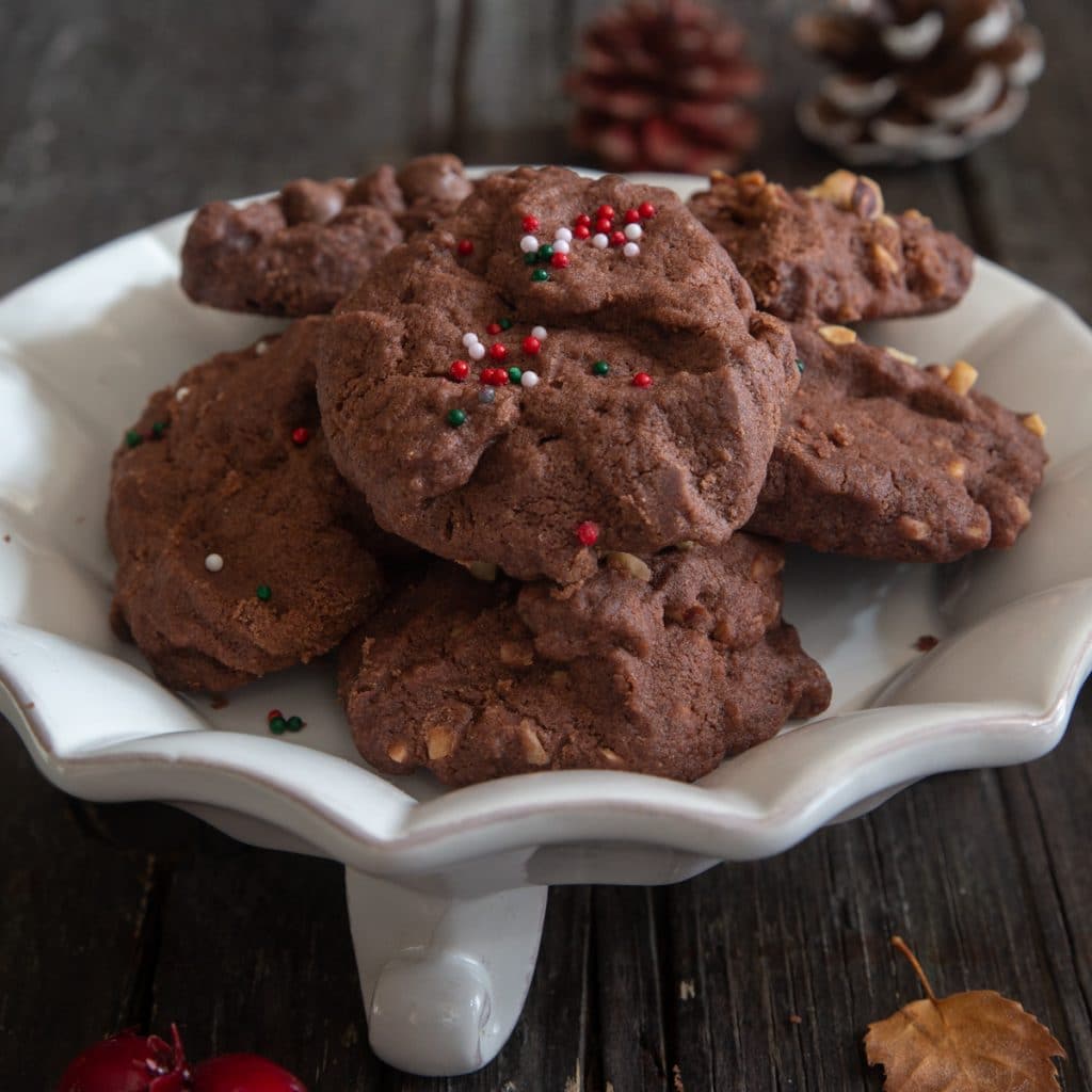 Chocolate shortbread cookies on a white plate.