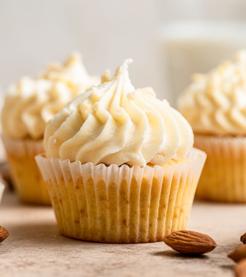 Almond Cupcakes on a wooden board.