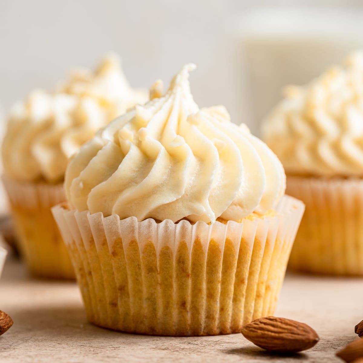 Almond Cupcakes on a wooden board.