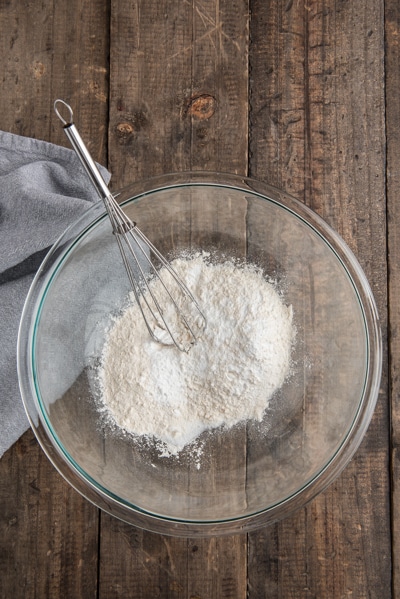 Whisking the dry ingredients in a glass bowl.