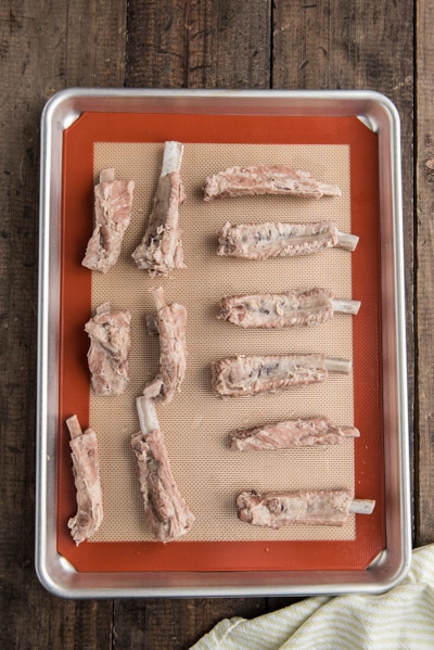 Boiled spareribs on a cookie sheet.