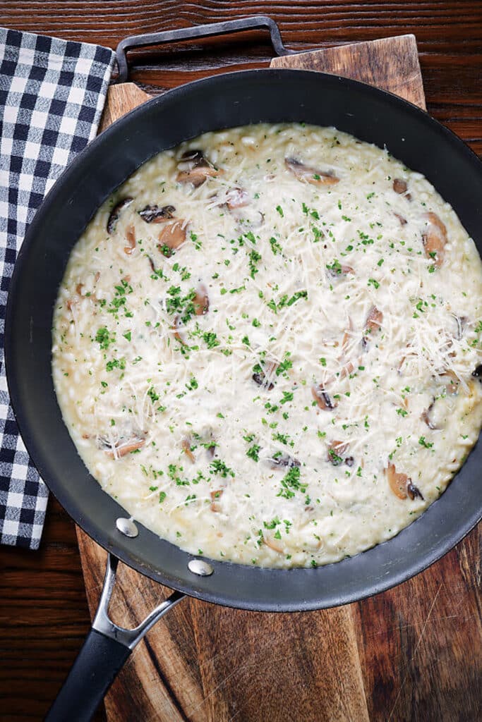 Mushroom risotto in a black pan.