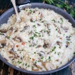 Mushroom risotto in a black pan.
