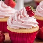 Strawberry cupcake on a white stand.