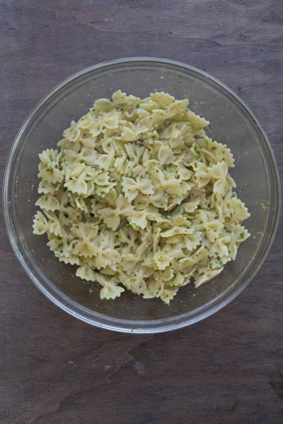 The cooked pasta mixed with pesto.