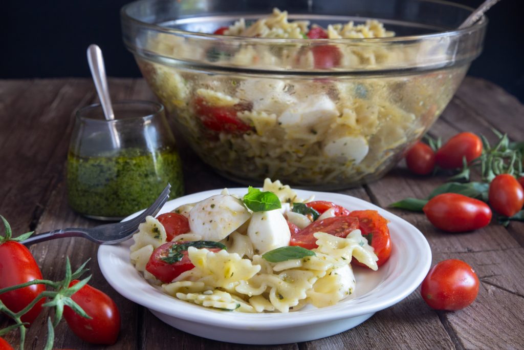 Pasta salad in a glass bowl and on a plate.