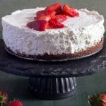 Ricotta cheesecake on a black cake stand.