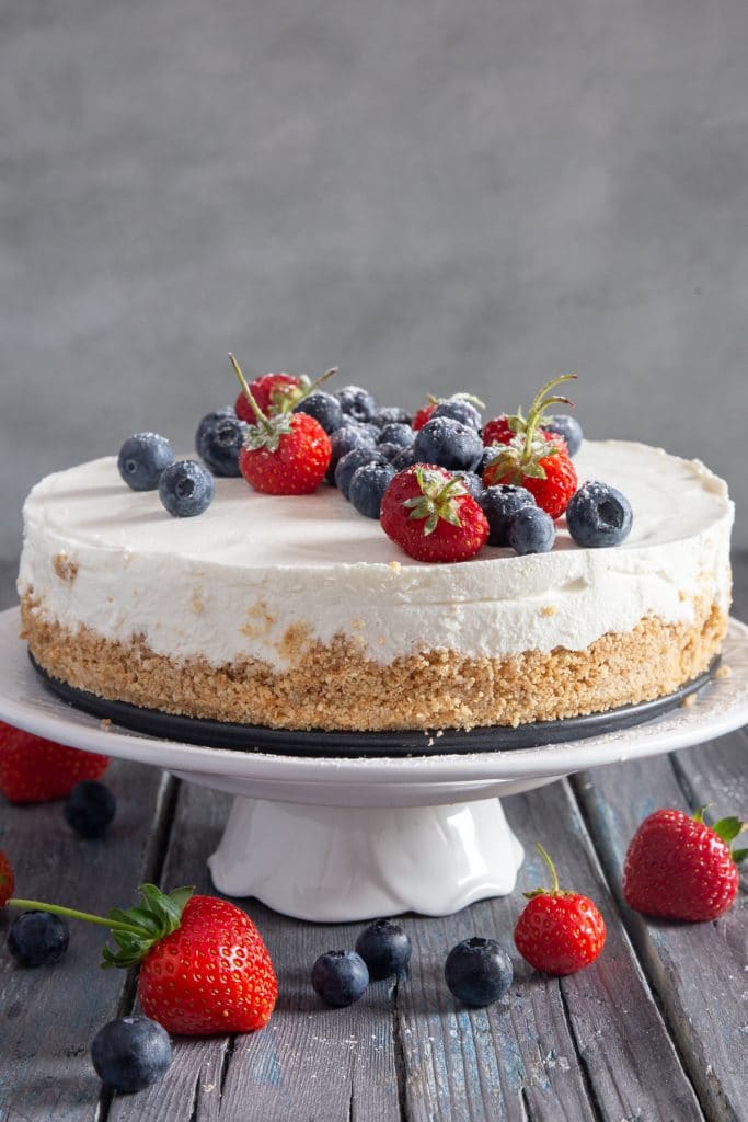 Greek yogurt pie on a white cake stand.