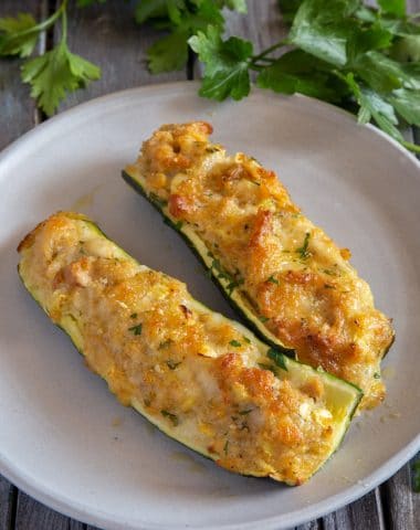 2 zucchini boats on a white plate.