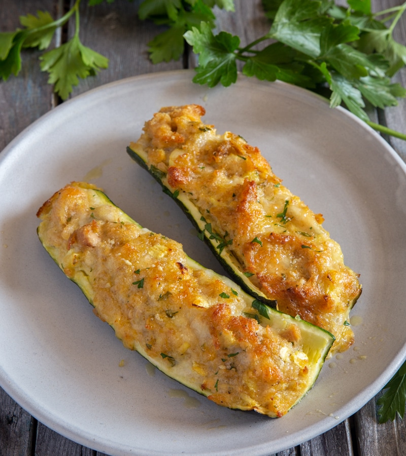 2 zucchini boats on a white plate.