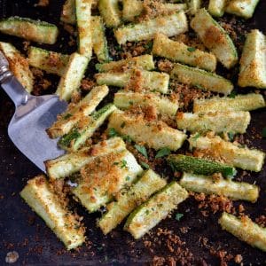 Baked zucchini on a cookie sheet.