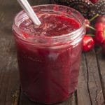 Cherry jam in a glass jar.