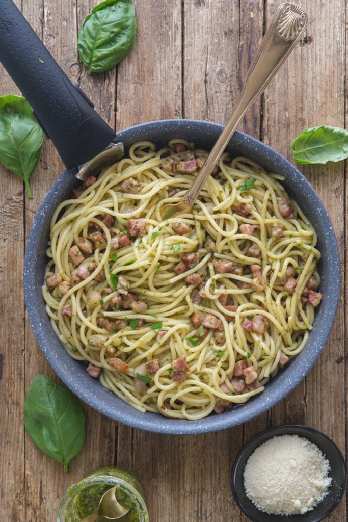 Pesto pasta in a black pan.