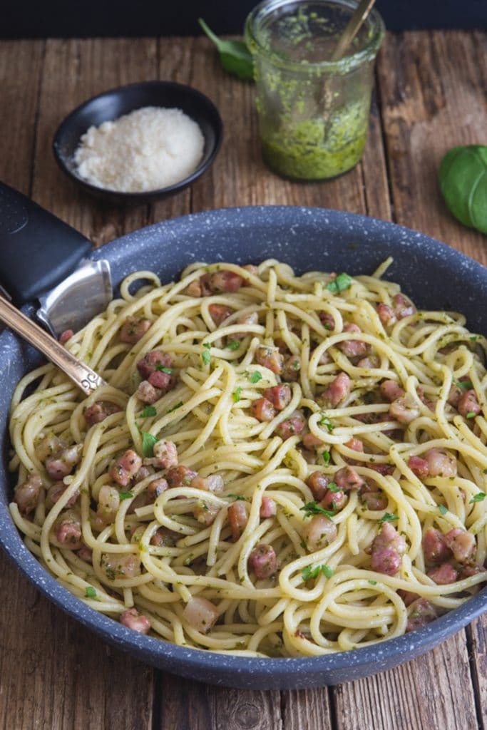 Pesto pasta in a black pan.