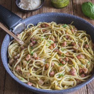 Pesto pasta in a black pan.