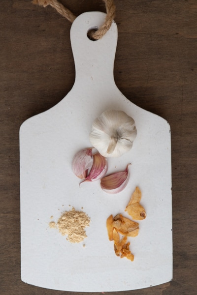 Garlic dried and fresh on a white board.