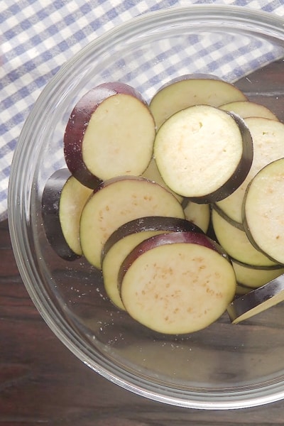 Sliced eggplant in a glass bowl.