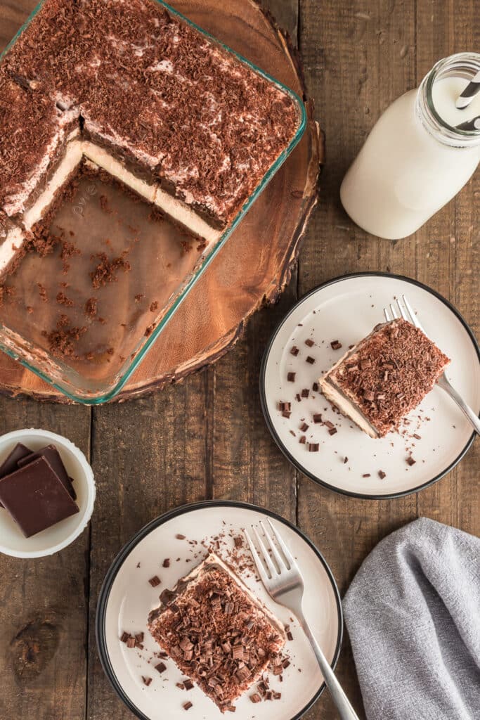 The dessert in a glass pan and two slices on white plates.