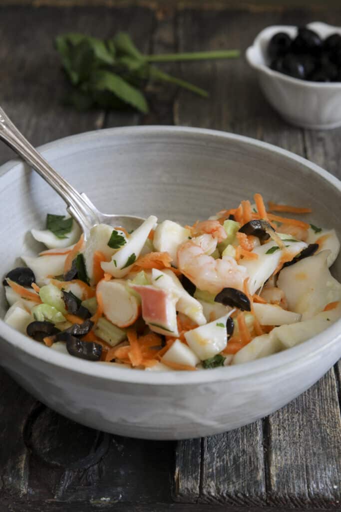 Seafood salad in a grey bowl.