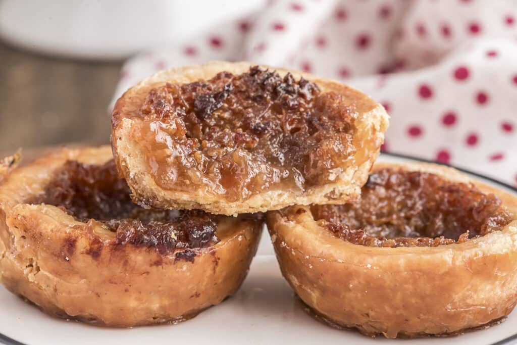 Three butter tarts with one cut in half.