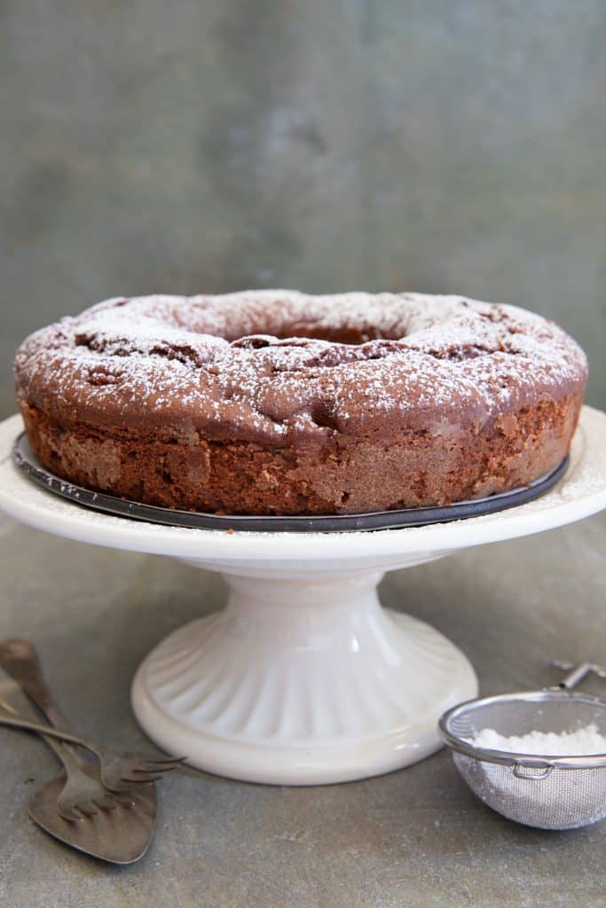 Pear cake on a white cake stand.