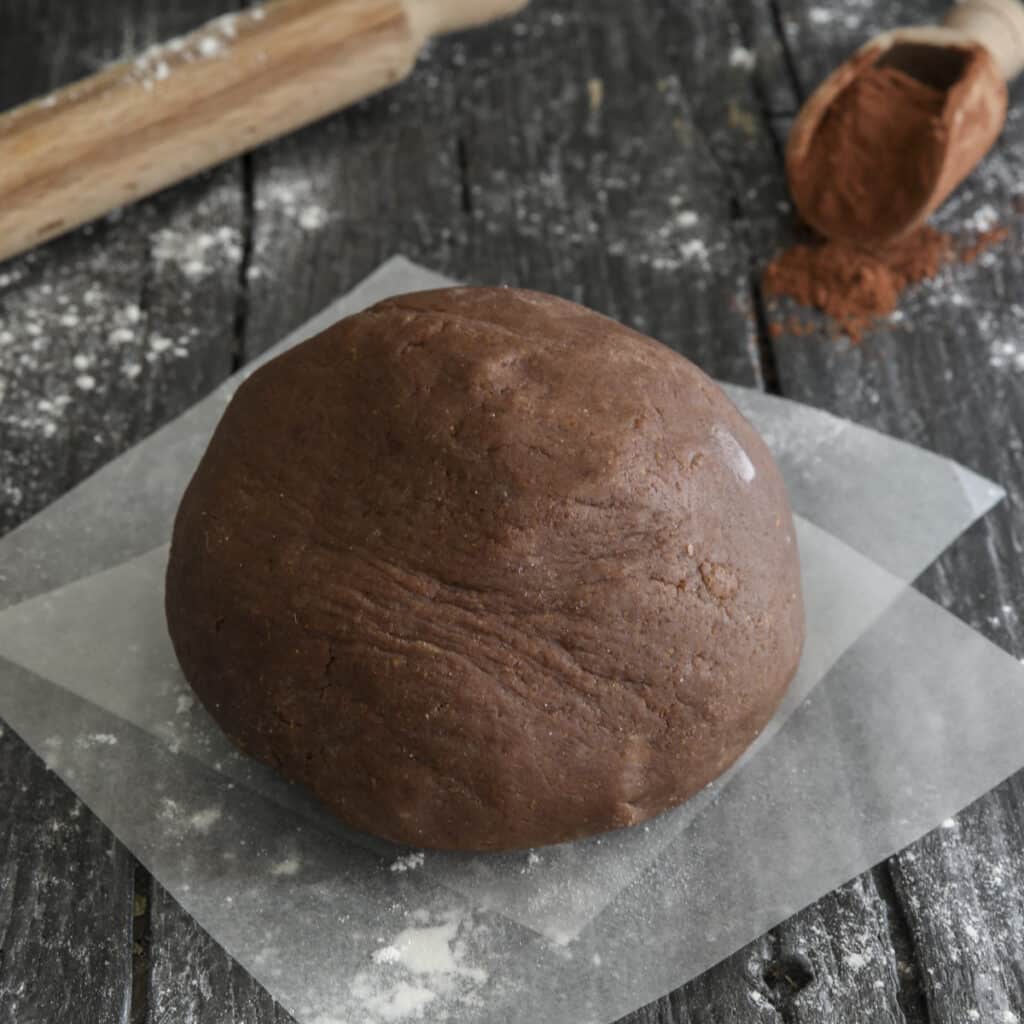 Chocolate pie dough on wax paper.