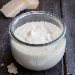 Parmesan cream in a glass jar.