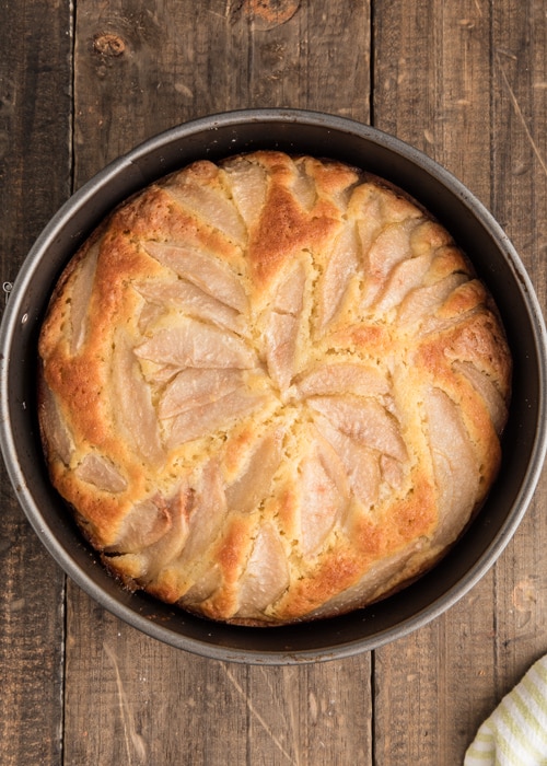 The baked pear cake in the cake pan.