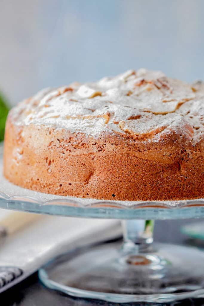 Pear cake on a glass cakes dish.