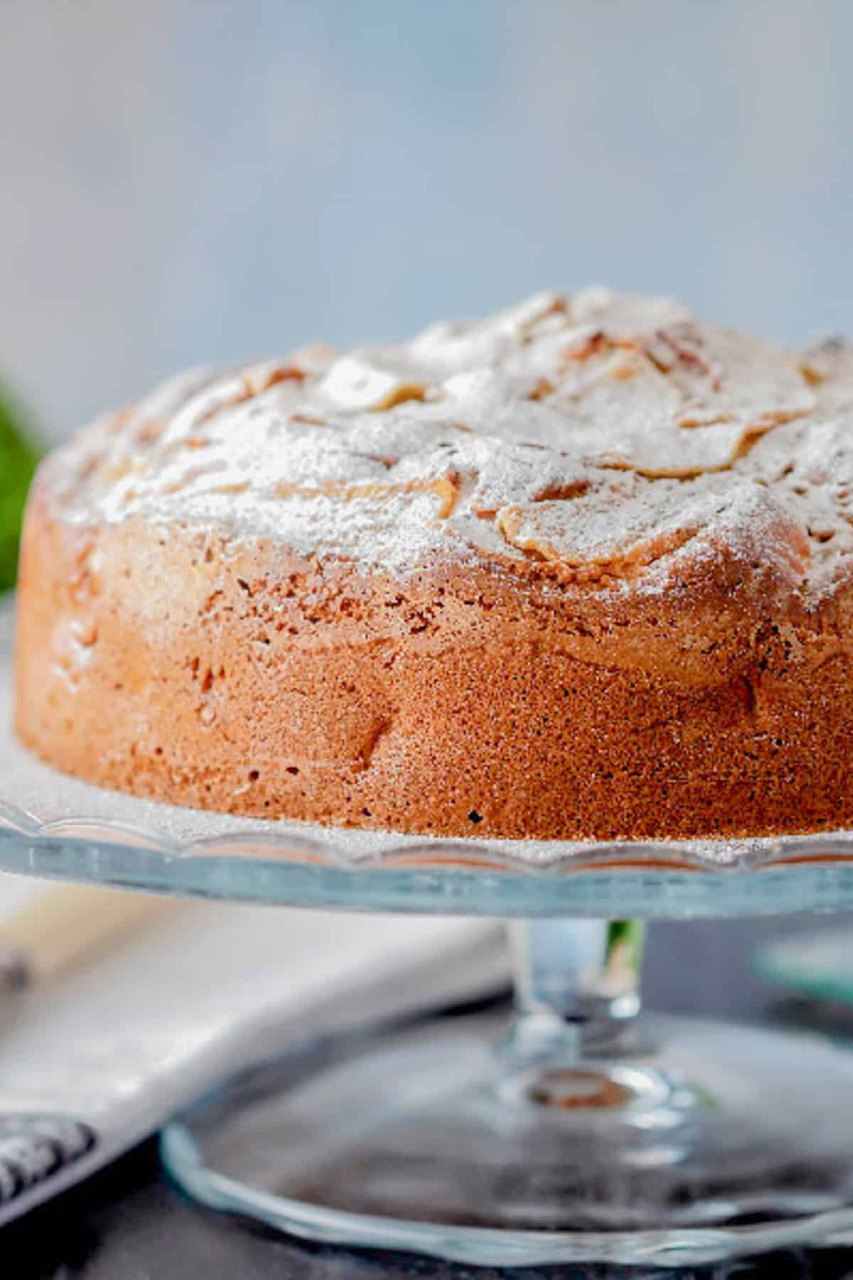 Pear cake on a glass cakes dish.