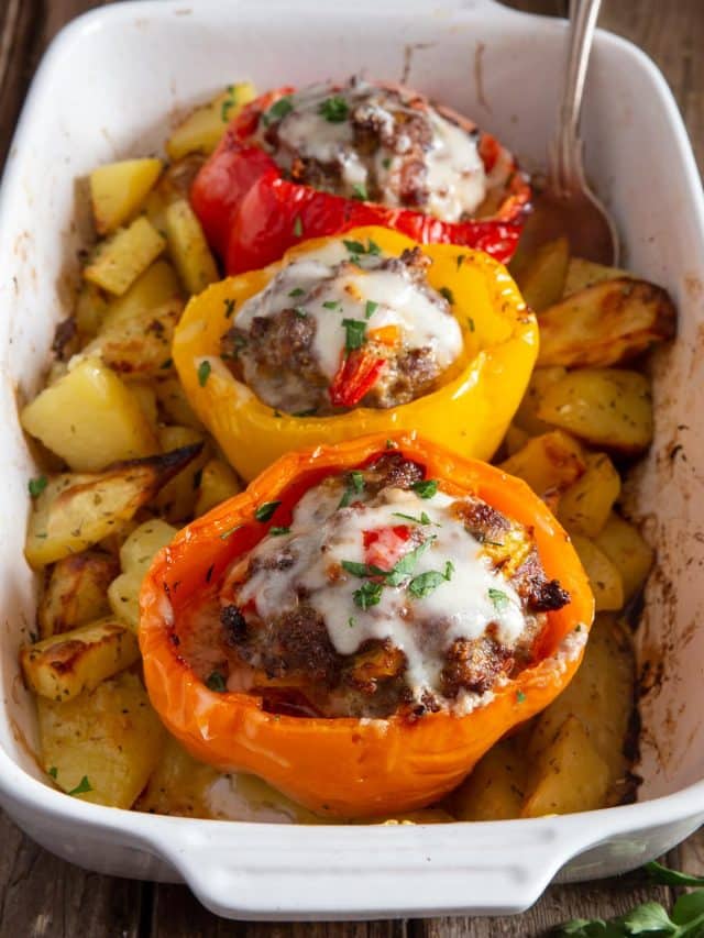 Stuffed peppers in a white pan.