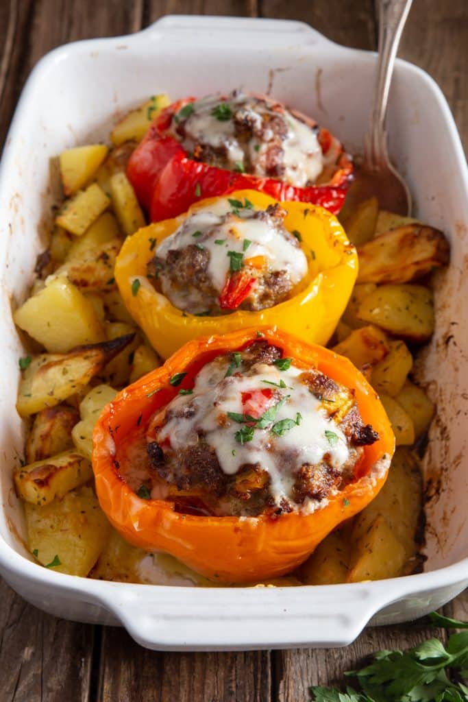 Stuffed peppers in a white pan.
