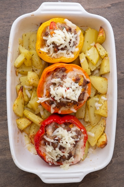 The peppers and potatoes baked in a white pan.