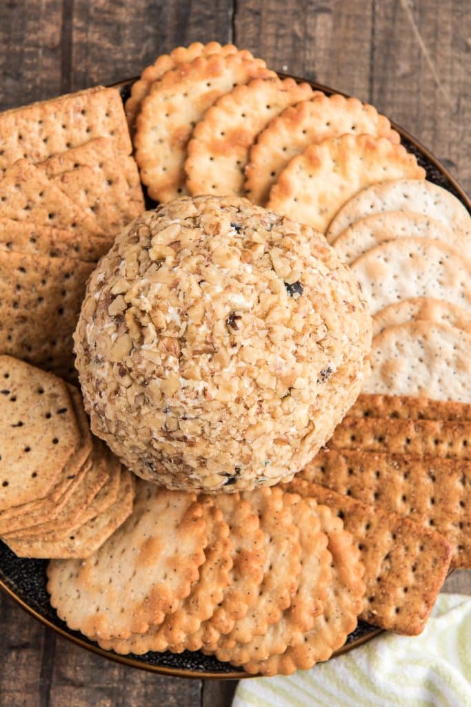 Cheeseball on a plate with crackers.