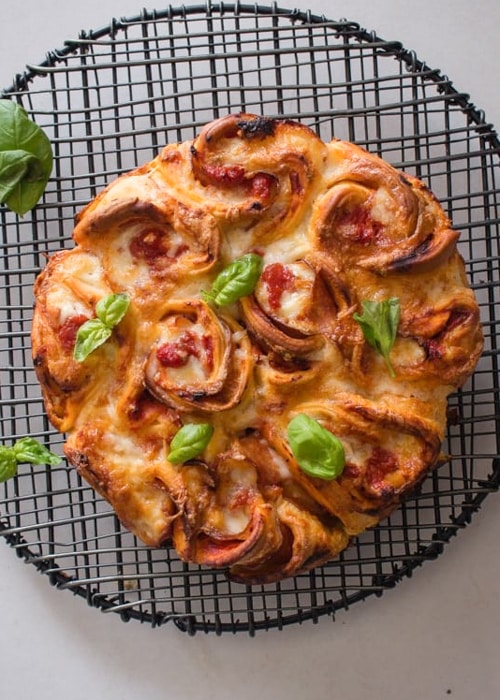 Pizza rose bread on a wire rack.