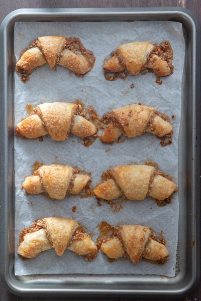 Rugelach baked on a cookie sheet.