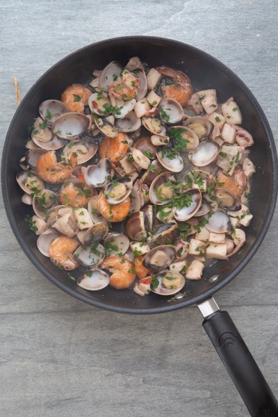 The cooked seafood pasta in the pan.