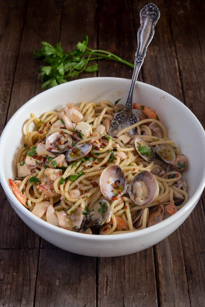 Pasta with seafood in a white bowl.