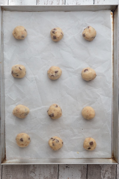 Dough rolled into balls and on the prepared cookie sheet.