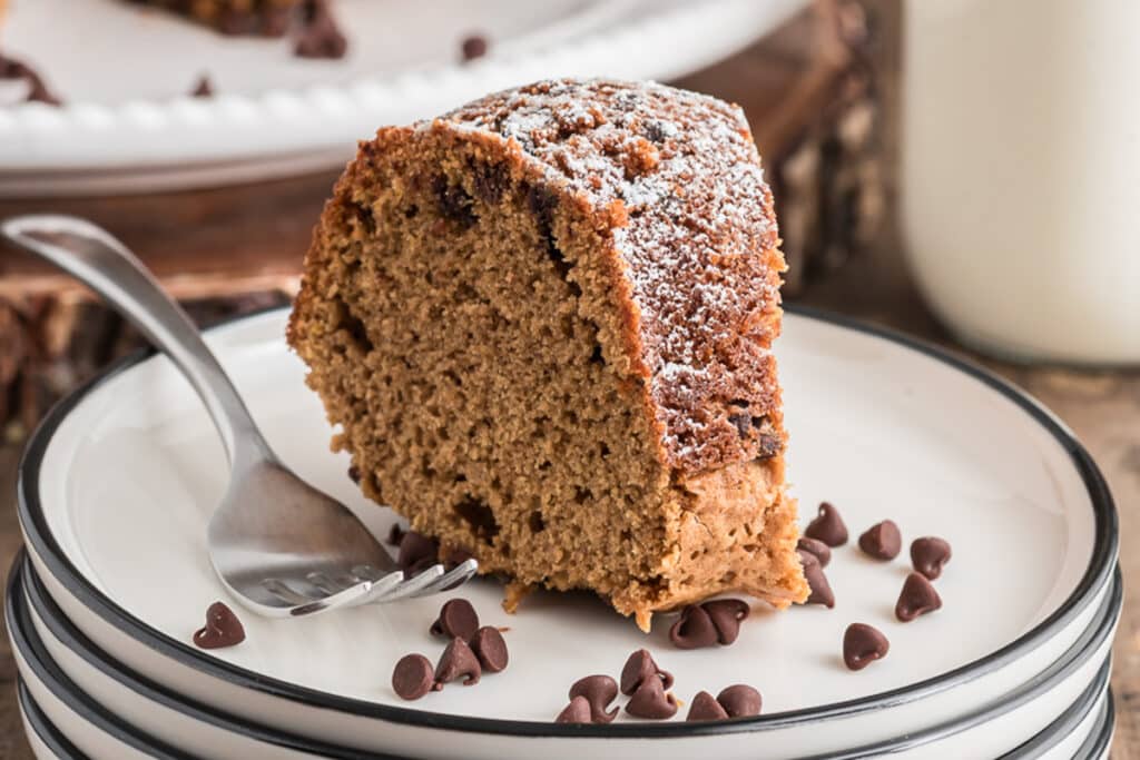 A slice of cake on a white plate.