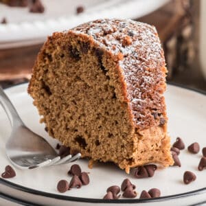 A slice of cake on a white plate.