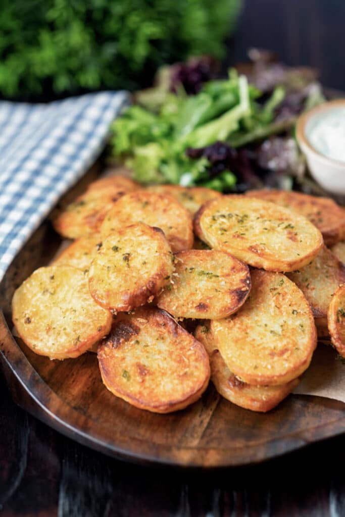 Baked potato slices on a brown dish.