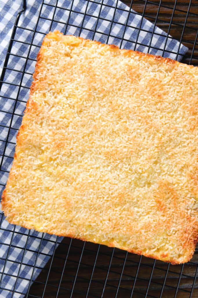 Pineapple coconut whole baked cookie on a blue checkered napkin.