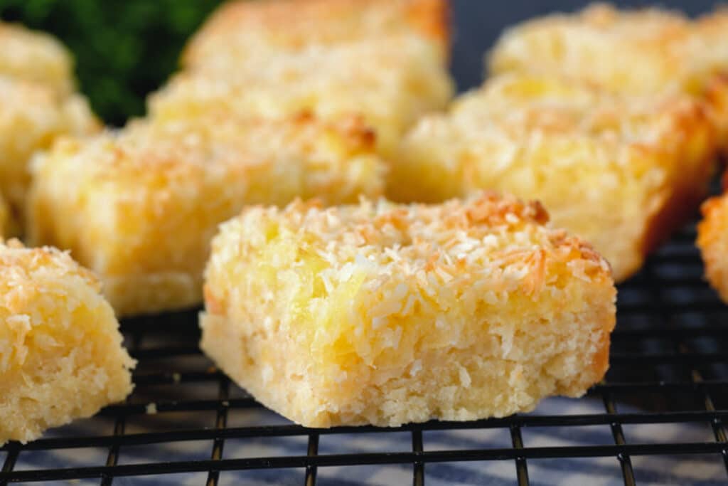 Coconut bars on a wire rack.