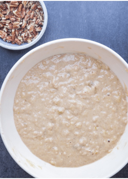 The batter for the bread in a white bowl.