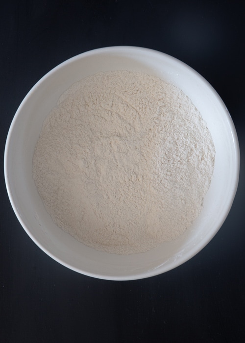 Dry ingredients whisked in a white bowl.