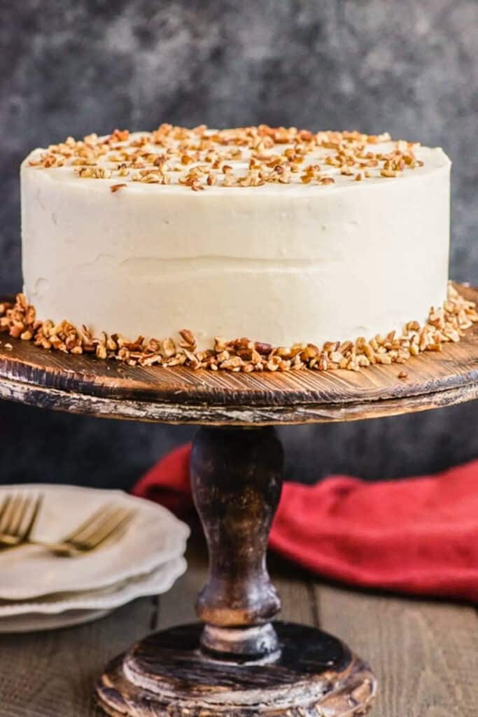 Carrot cake on a cake stand.