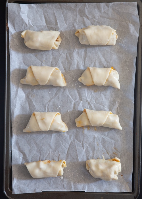 The roll ups before baked on the baking sheet.