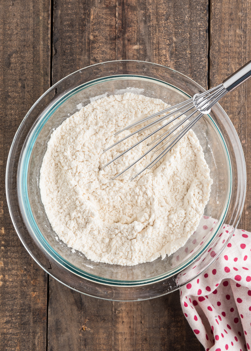 The dry ingredients whisked in a glass bowl.