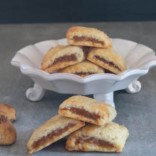 Fig cookies on a white dies and 3 stacked.